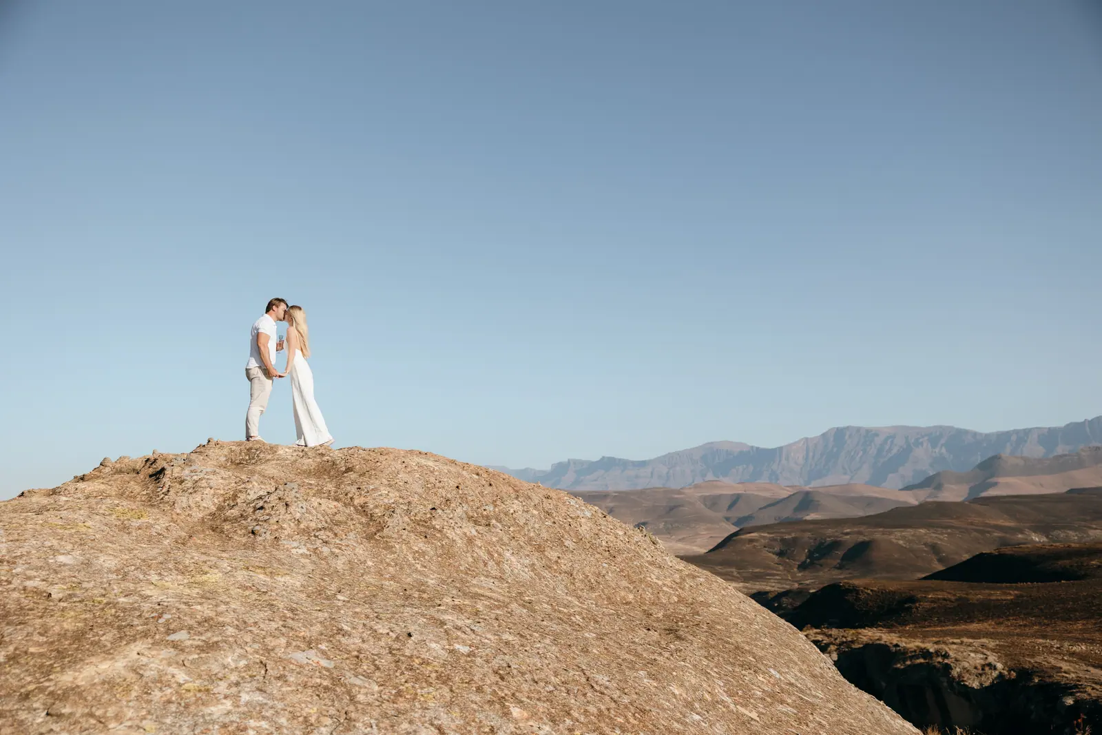 Standing together on a rise, mountains stretching away